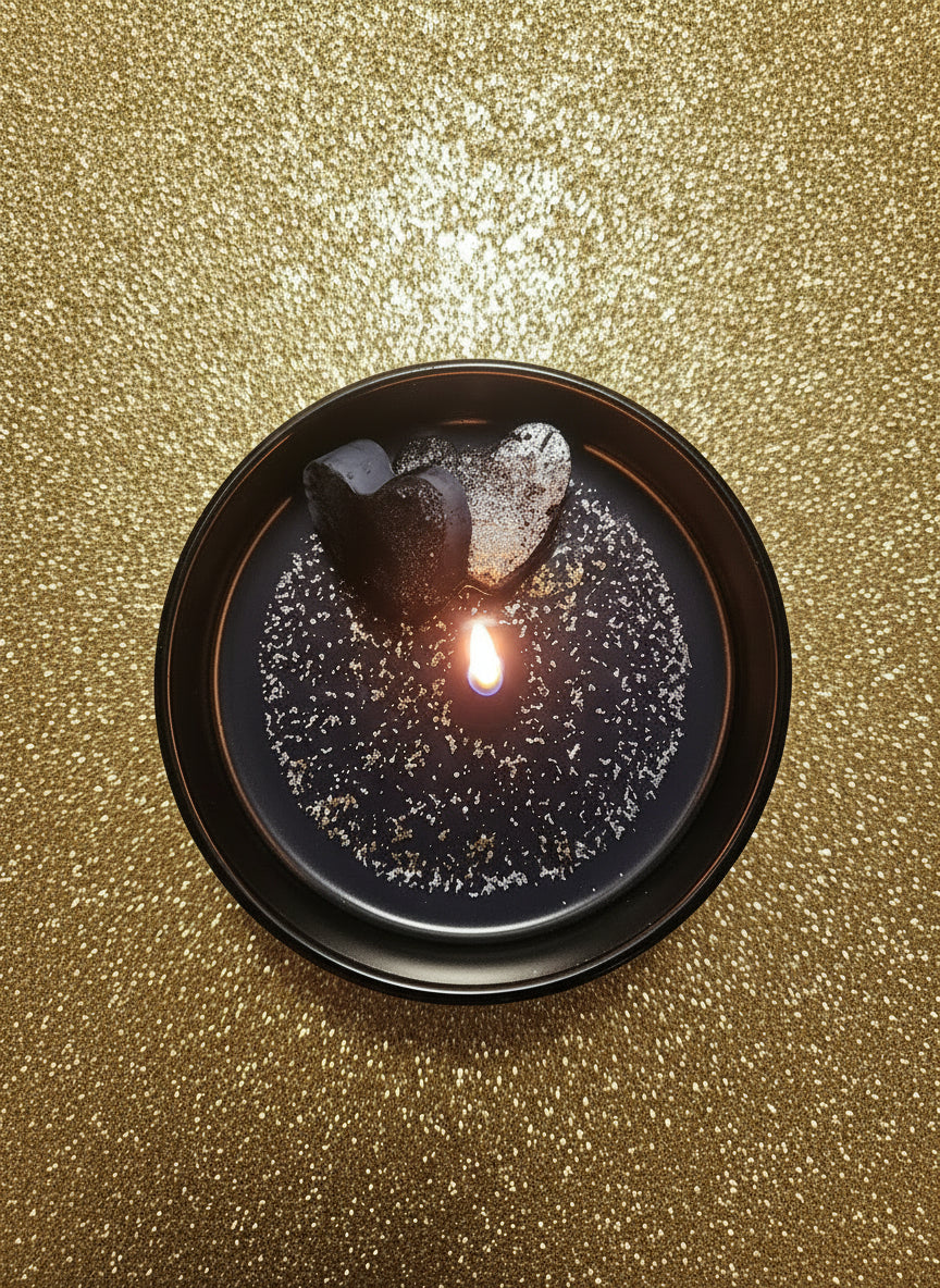 Black ceramic plate with speckled design on a wooden surface